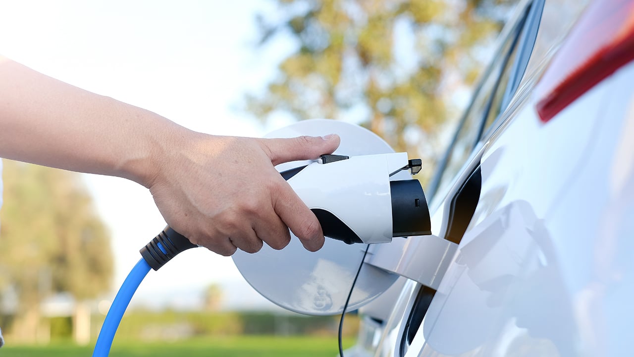 a person charging their electric car