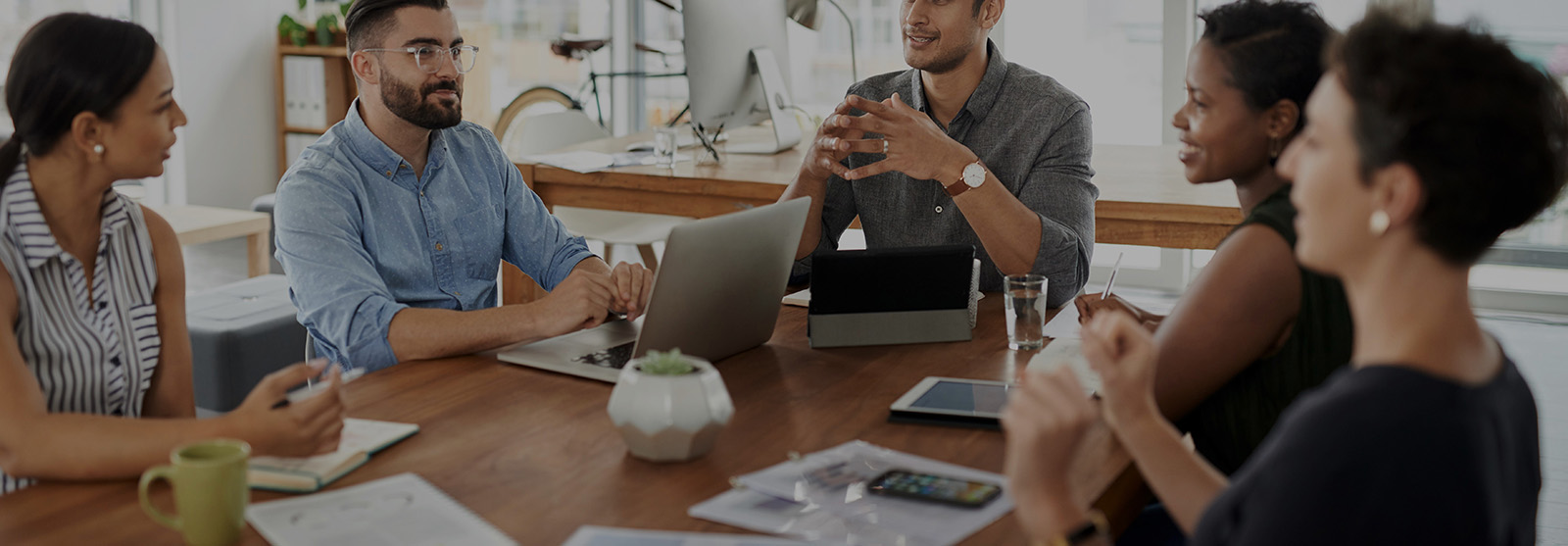 Men and women collaborating around an office table