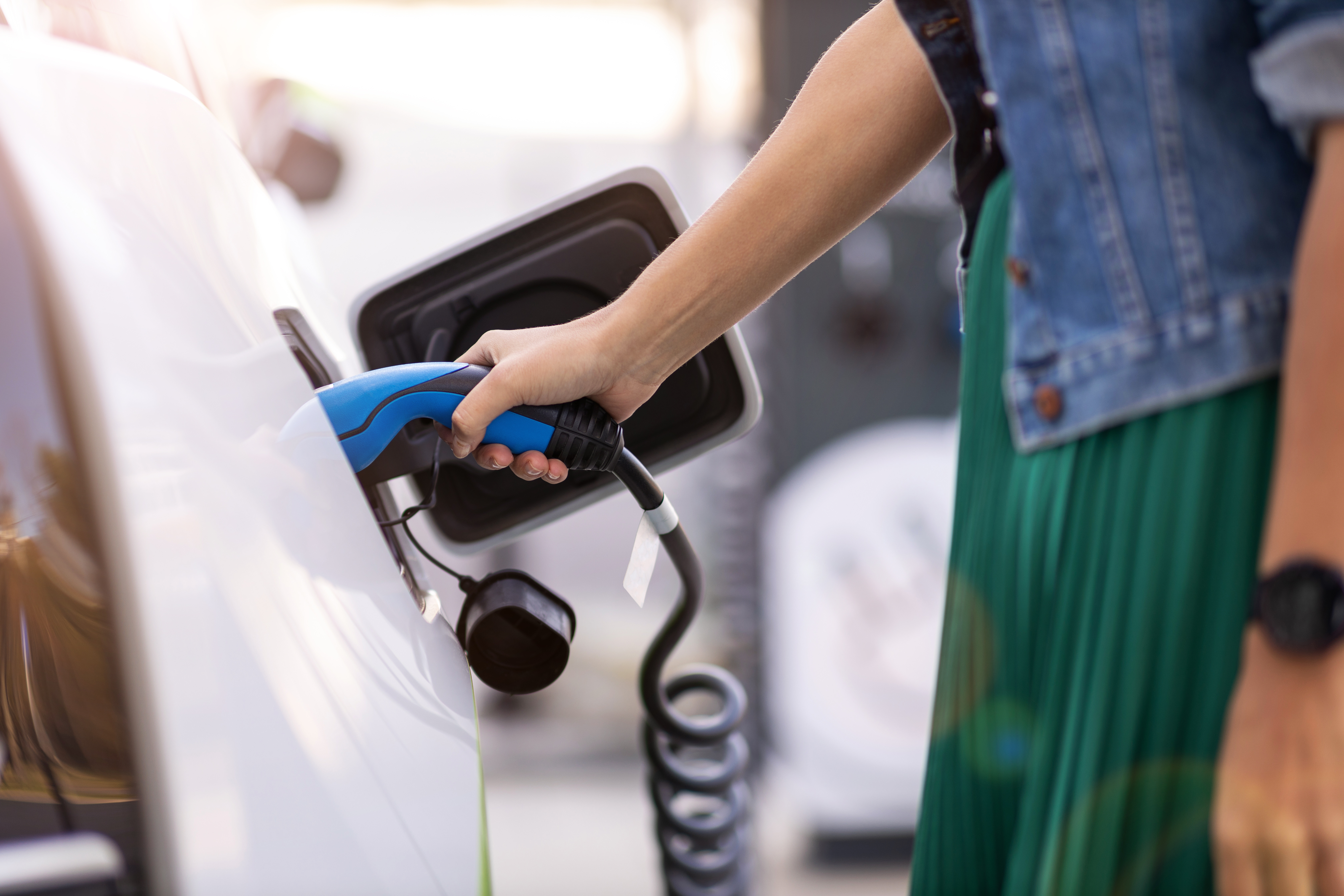 Woman charging her EV