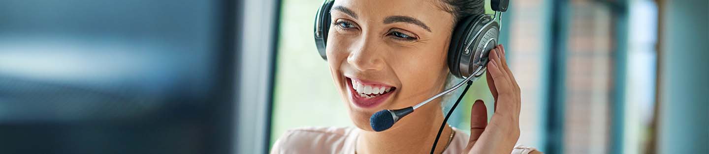 a women on a headset talking to someone laughing