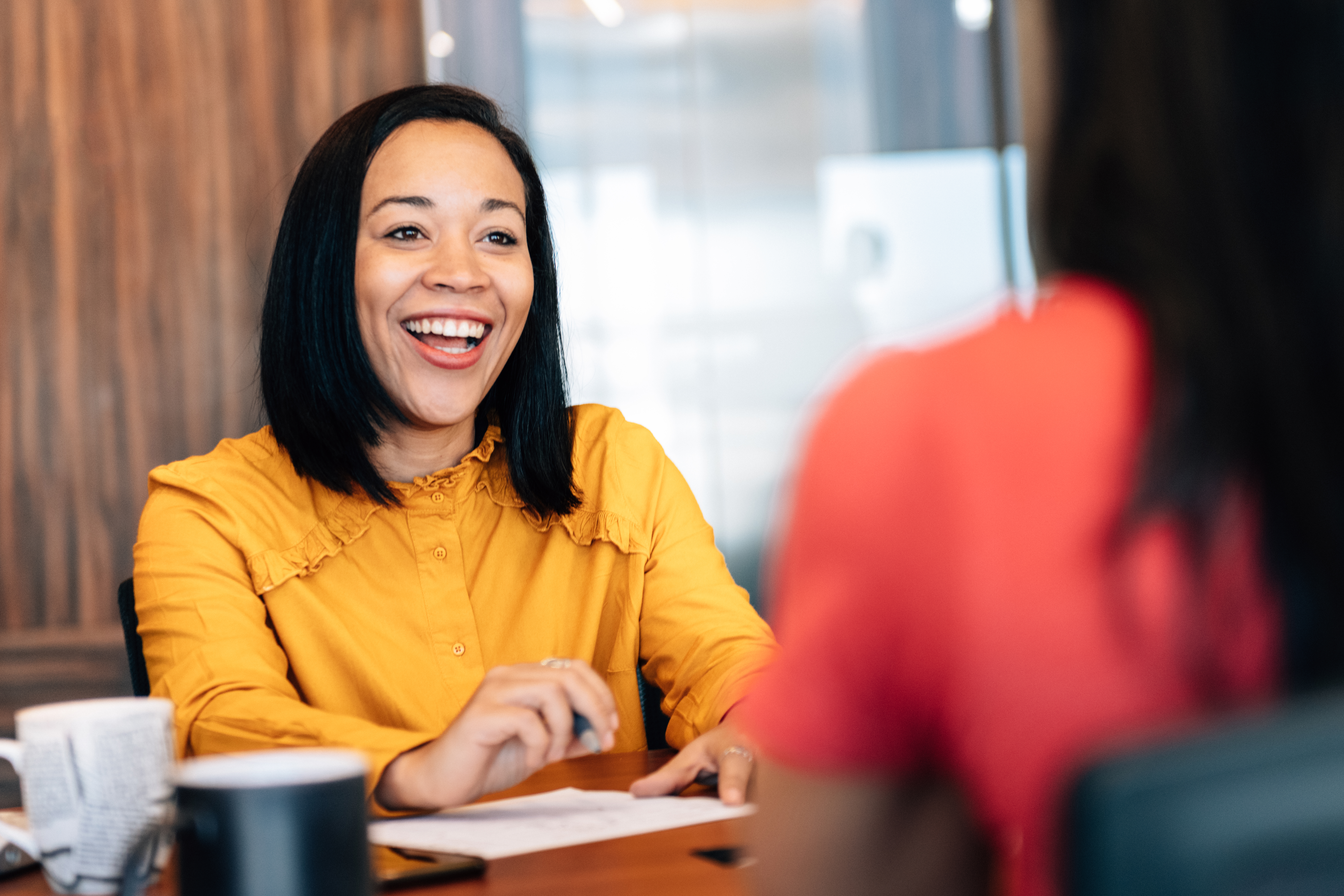 A happy girl talking to another woman