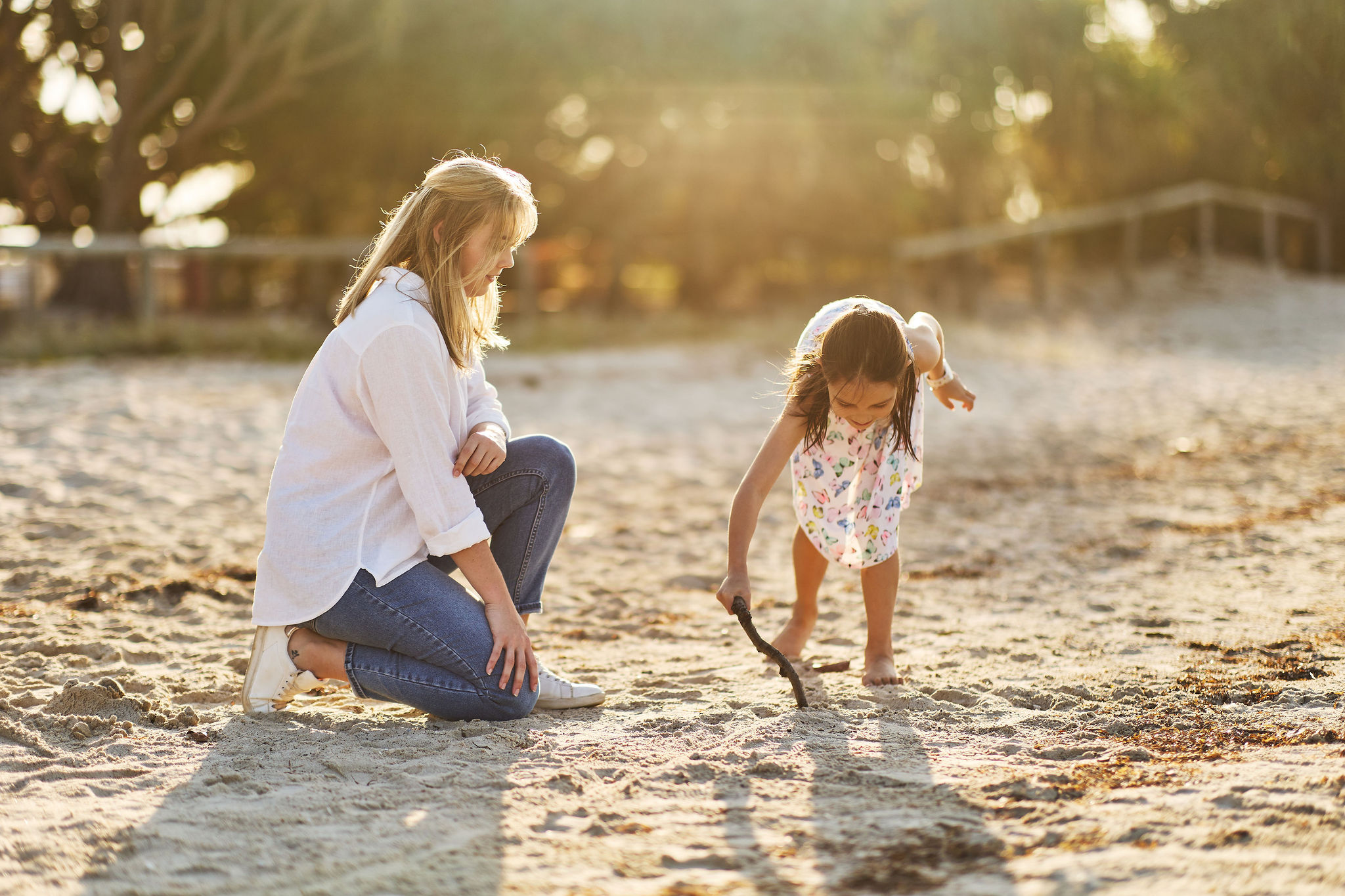 women and child happily playing on the beach