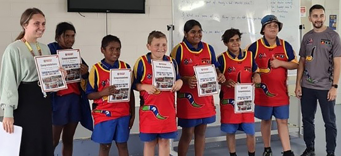 a group of kids and teachers posing with their awards