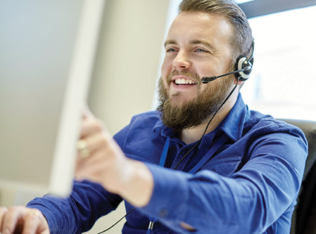a businessman talking on a headset smiling 