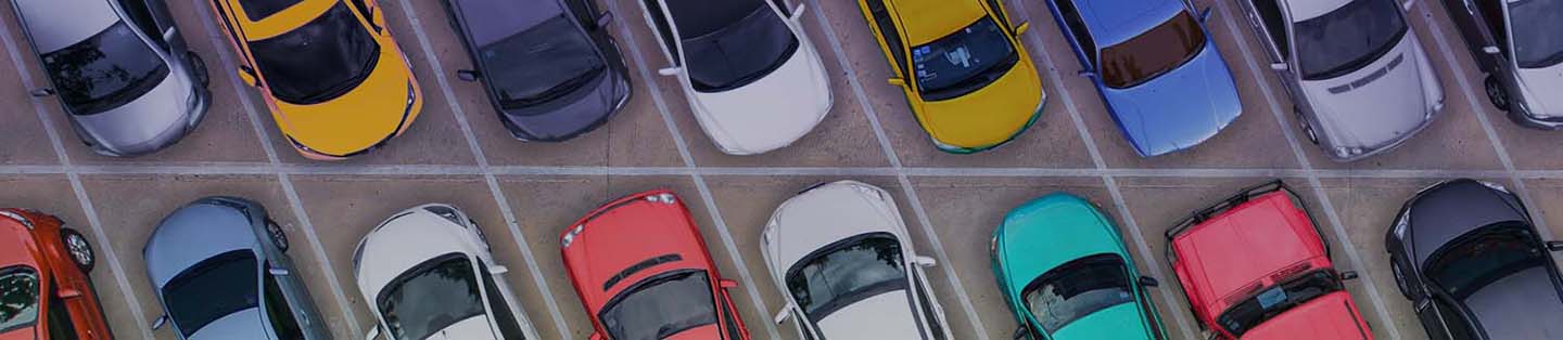 a top down view of full parking lot of cars