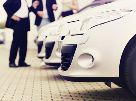 cars lined up at a dealership  