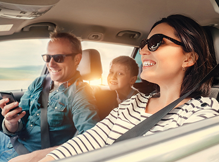 a young family in a car smiling
