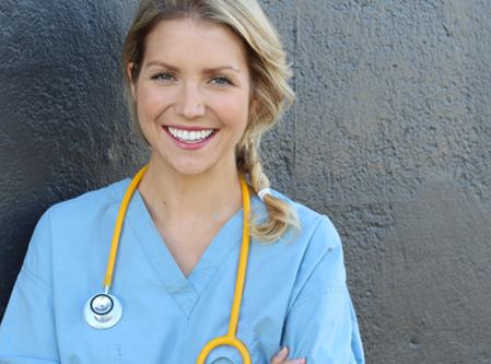 a nurse smiling looking at the camera 