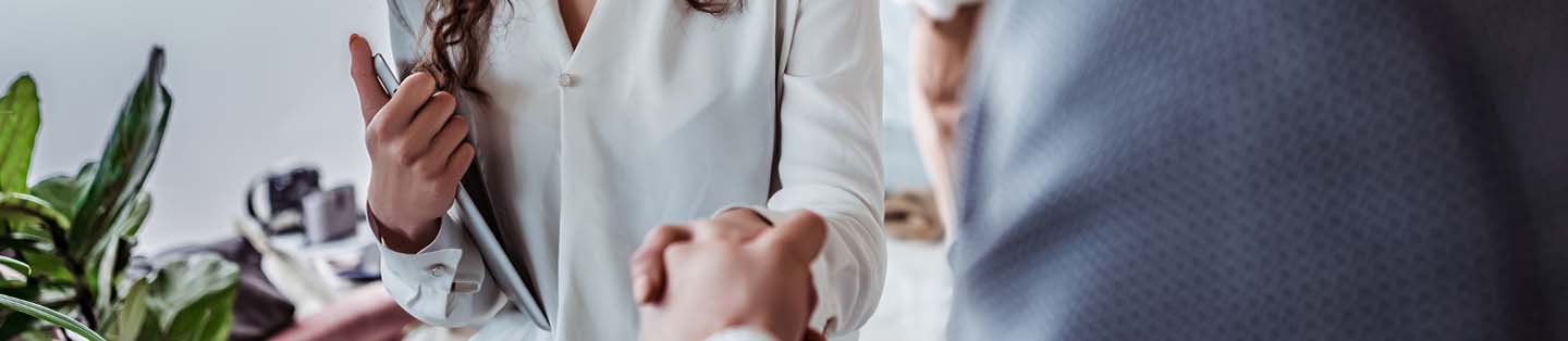 two people greeting each other shaking hands